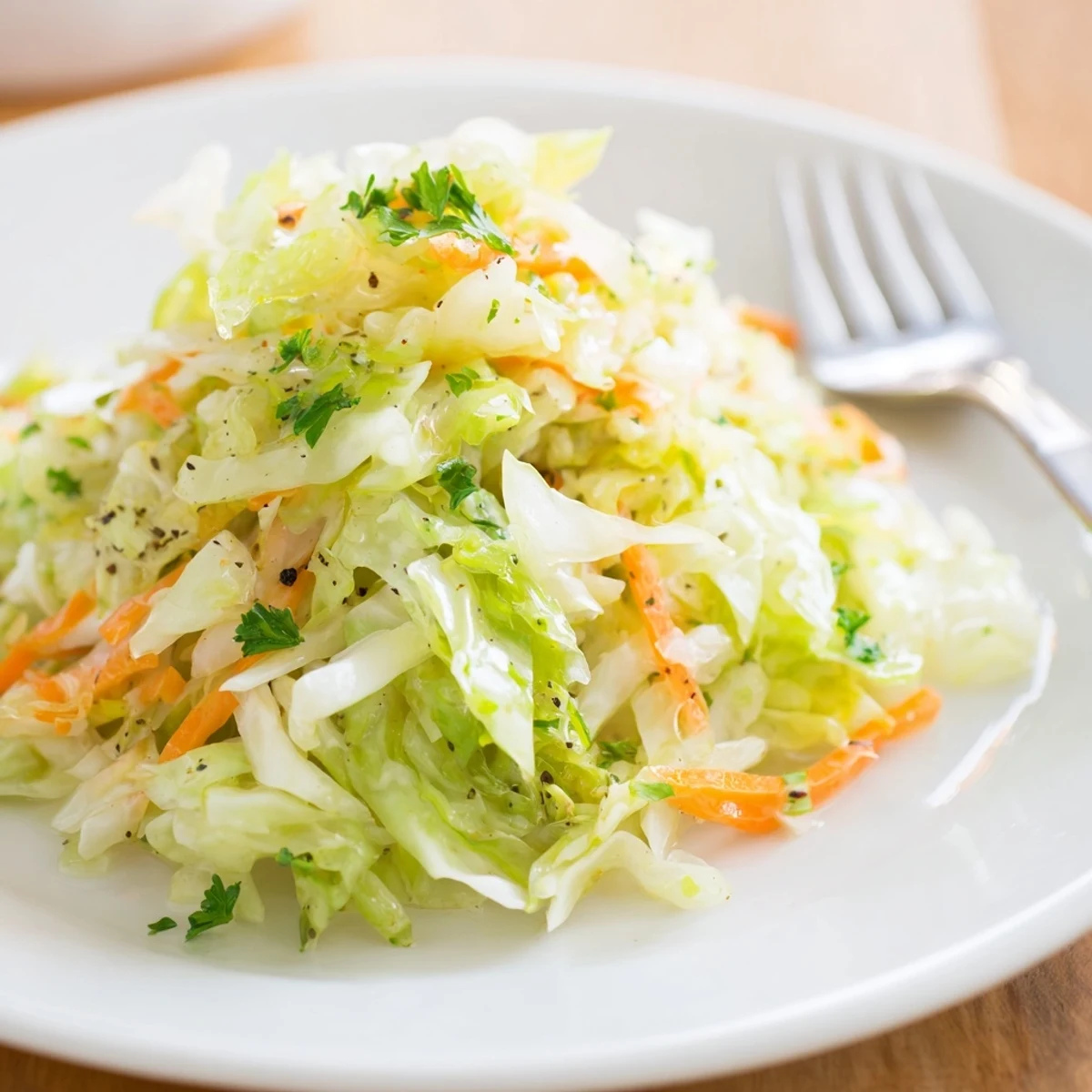 Crisp and tangy Classic German Cabbage Salad garnished with fresh parsley slices.  