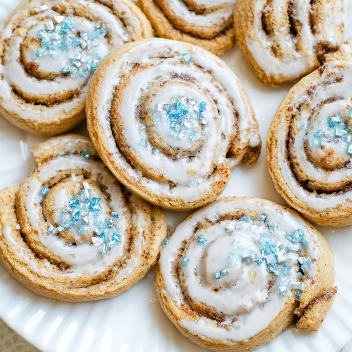 Warm, spiced Gingerbread Hanukkah Cinnamon Roll Cookies sprinkled with holiday-themed sugar crystals.