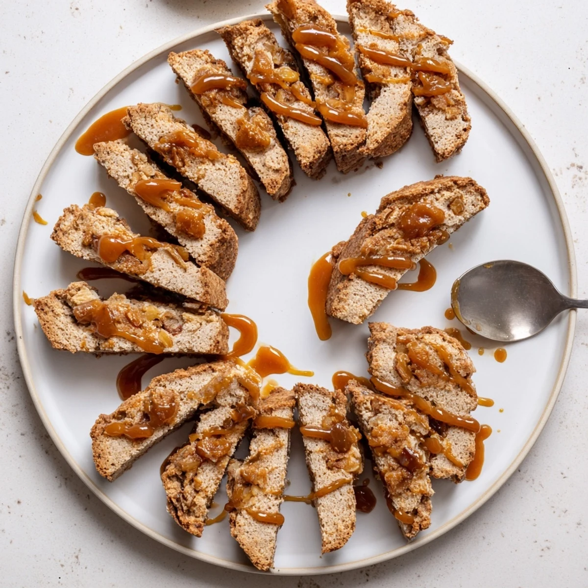 Golden Caramel Apple Biscotti Dunkers arranged on a plate, ready to complement warm cider.