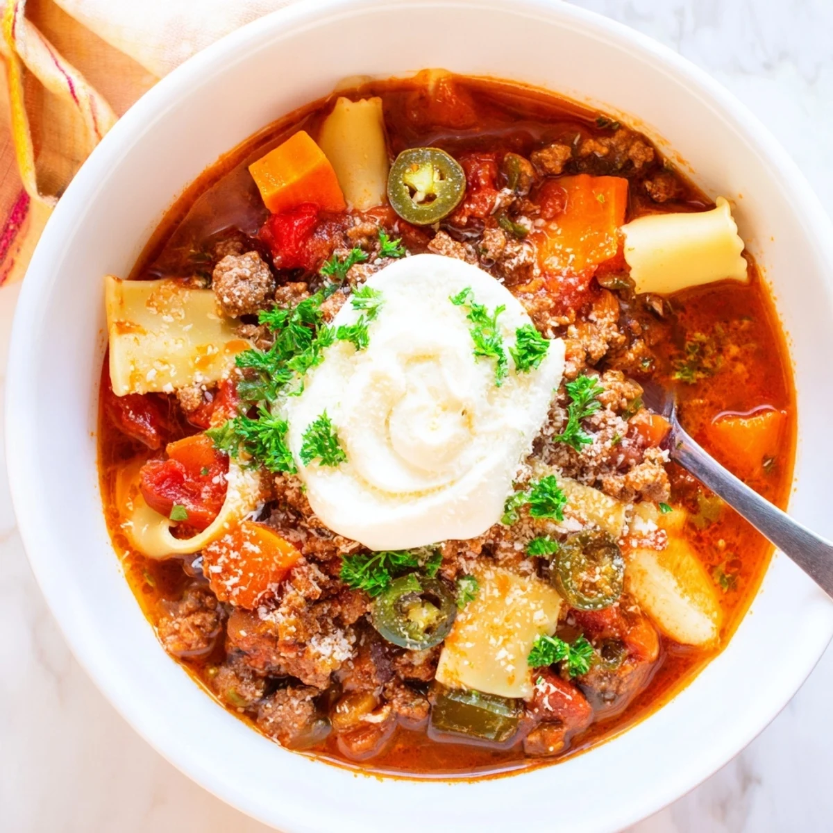 Delicious Lasagne Soup featuring rich flavors and a zesty, cheesy topping.