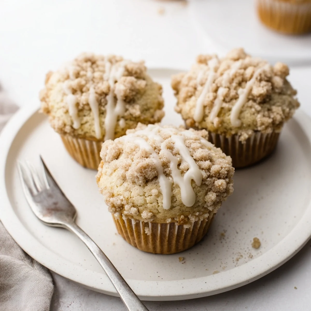 Deliciously spiced eggnog muffins drizzled with glaze, ideal for cozy winter indulgence.
