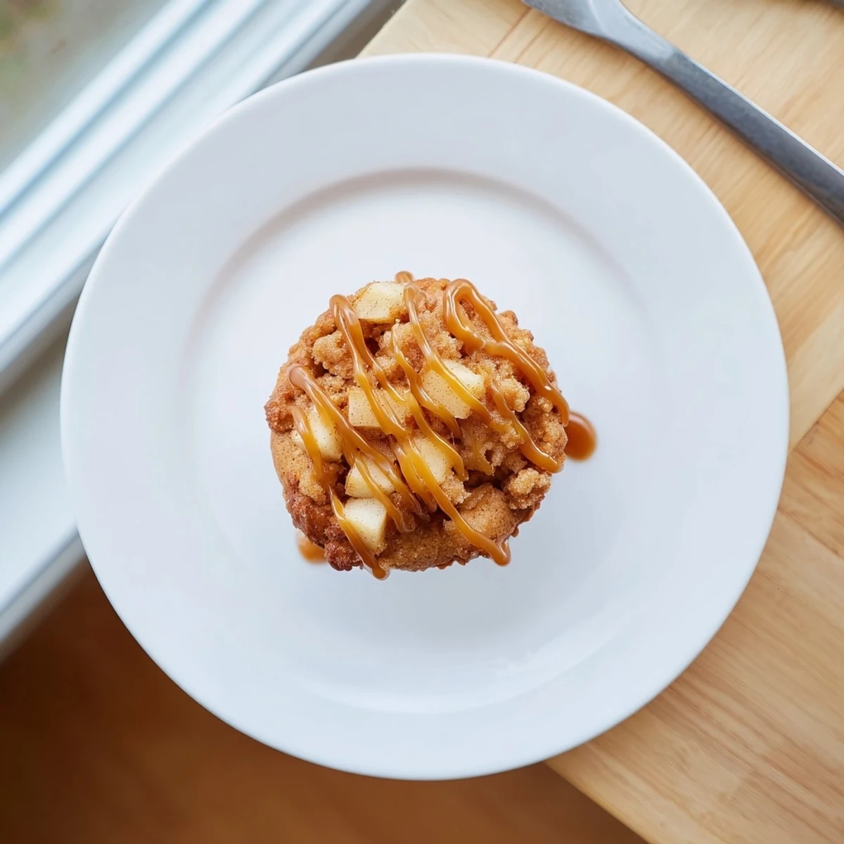 Delicious cinnamon-spiced caramel apple fritter muffin cups, perfect for any dessert table.