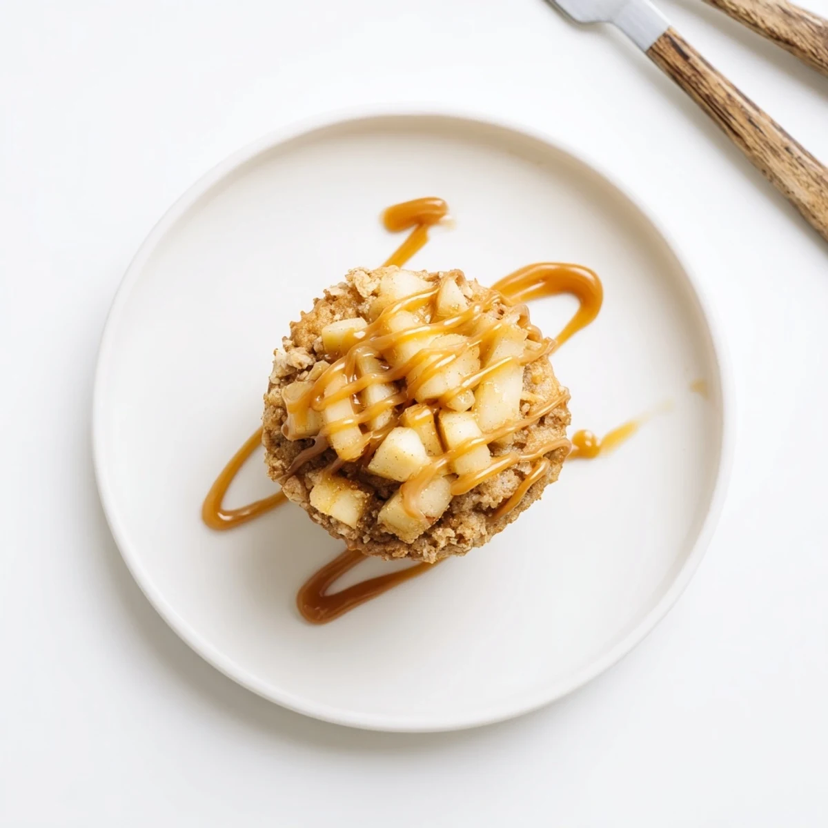 Warm apple fritter muffin cups topped with gooey caramel, inviting and full of flavor.