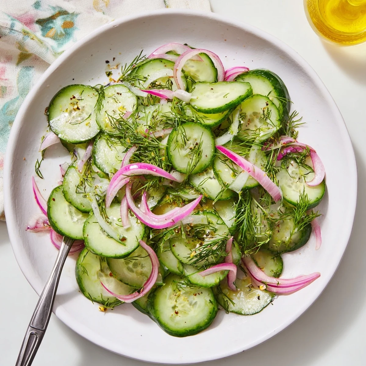 A close-up of Lemon Dill Cucumber Salad: crisp cucumbers and red onions tossed with lemon dressing.