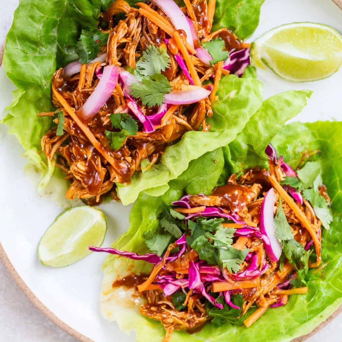 Smoky BBQ jackfruit, nestled in crisp lettuce, makes a delightful, plant-based meal, perfect for a sunny day.