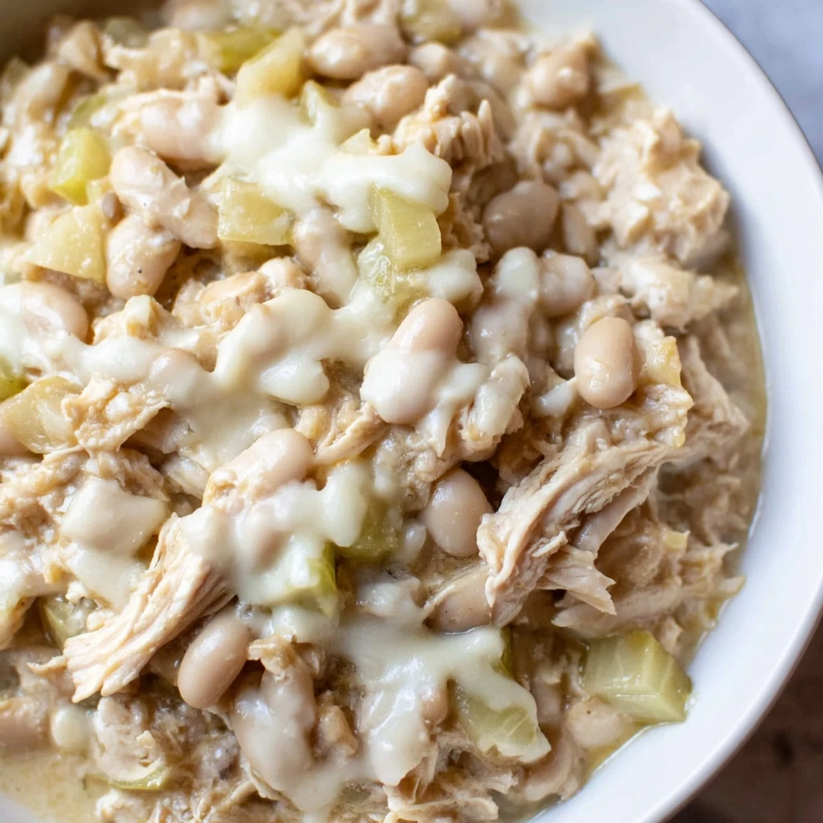 Steaming bowl filled with the creamy 35-Minute White Cheddar Apple Chicken Chili, ready to enjoy.