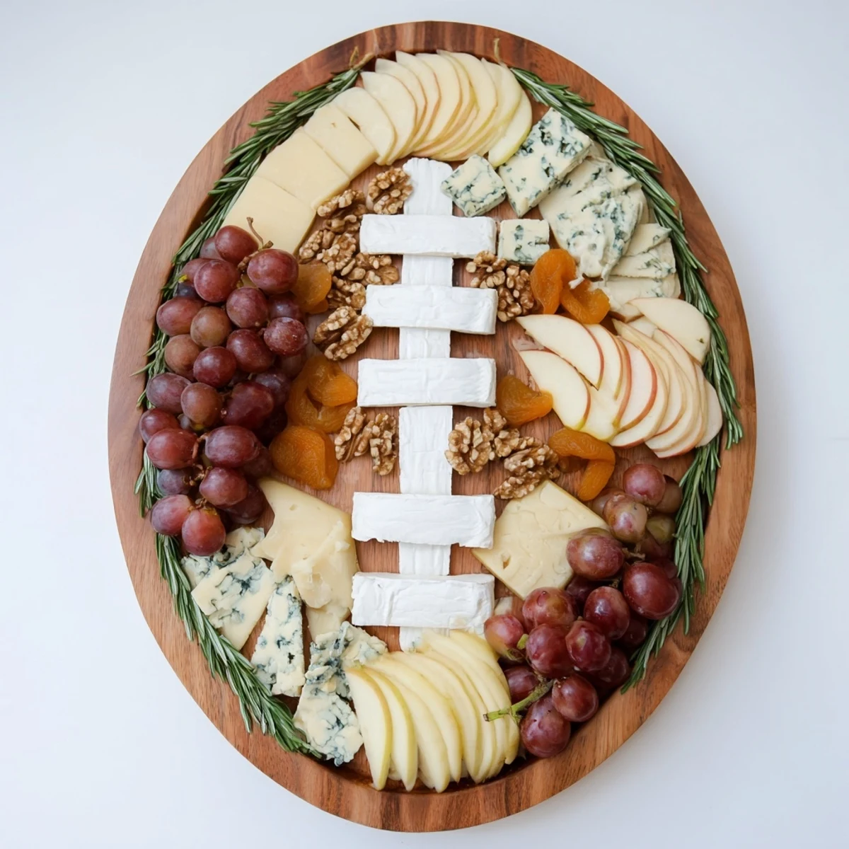 A festive Rugby Ball Cheese Board showcases creamy Brie and nutty Comté, perfect for entertaining guests.