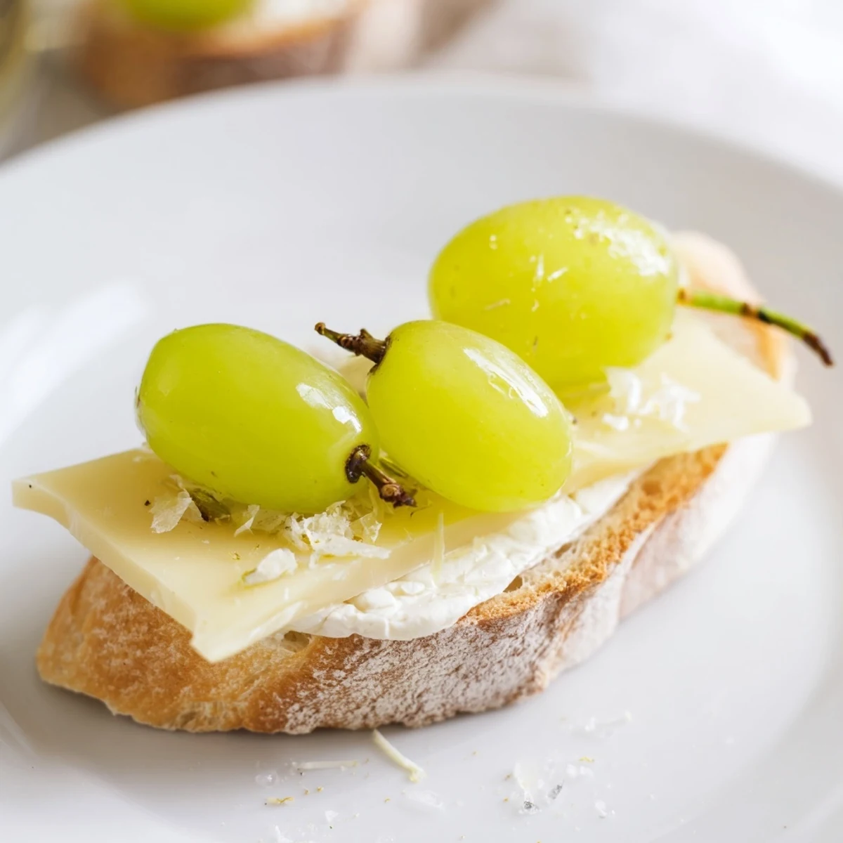 Close-up of Sparkling Champagne Toast: Glistening, golden grapes top creamy cheese, a celebratory appetizer.
