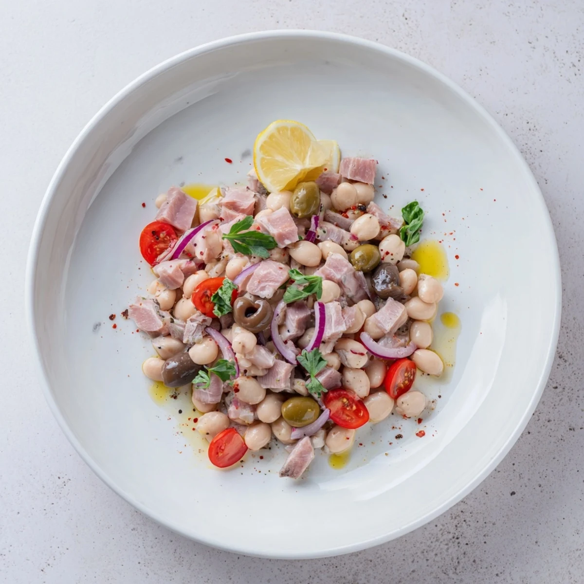 Creamy Dense Chickpea and Tuna Salad with red onion and parsley, a satisfying dish, ready to eat.