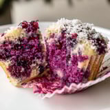 Freshly baked Ube Cranberry Mochi Muffins, blending sweet ube and tart cranberries perfectly.