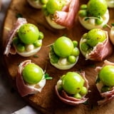 Festive Mistletoe Kissing Ball featuring green grapes, cheese, and herbs, perfect for holiday entertaining.