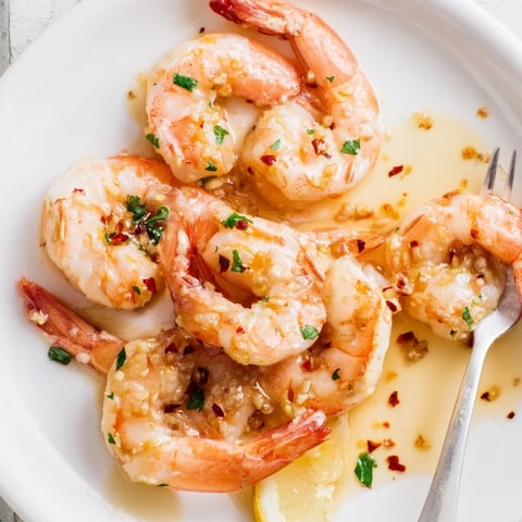 Succulent garlic shrimp simplified with butter, lemon, and fresh parsley garnish.  