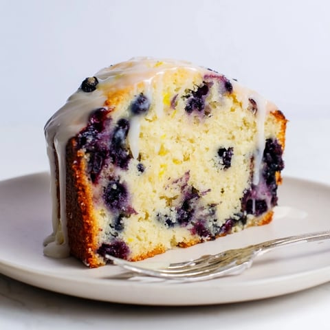 Moist blueberry lemon pancake bread topped with a sweet glaze, perfect for breakfast.  