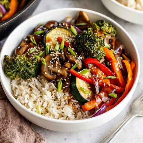 A colorful Japanese Hibachi Veggie Bowl with vibrant sautéed vegetables over fluffy rice.  