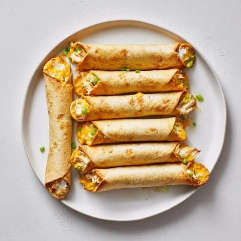 Crispy cream cheese chicken taquitos served with fresh salsa and lime wedges. 