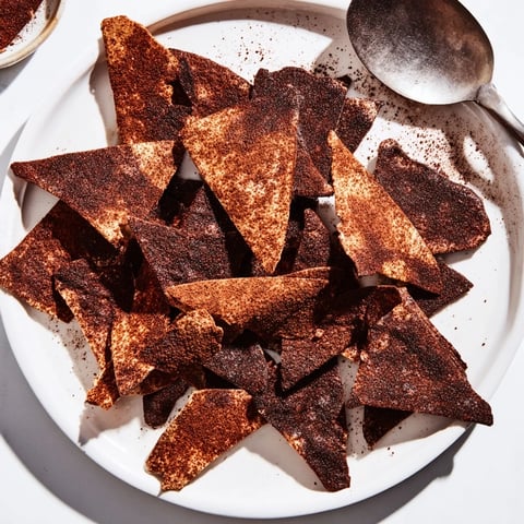 Crispy chocolate tortilla chips served with vibrant fruit salsa for delightful snacking.  