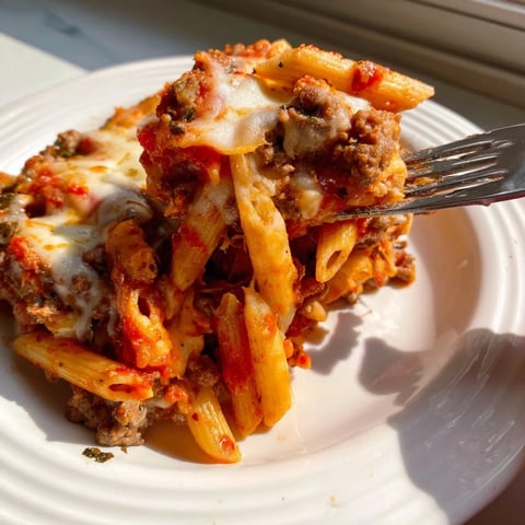 Cheesy Beef & Penne Bake topped with golden mozzarella, perfect for cozy family dinners.  
