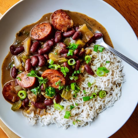 Hearty Red Beans & Rice with smoky sausage, served over fluffy white rice.  