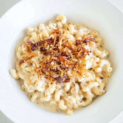 A golden brown baked Classic Mac & Cheese with BBQ Chicken, bubbling with melted cheese and delicious toppings.