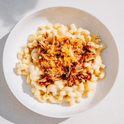Creamy Classic Mac & Cheese with BBQ Chicken, bubbling hot, a savory, beautiful family meal.