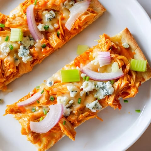 Steaming hot Buffalo Chicken & Blue Cheese Flatbread with melted cheese, ready to slice and serve.