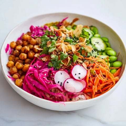 A colorful, layered ASMR Crunch Snack Bowl, with visible crunchy toppings and fresh herbs.