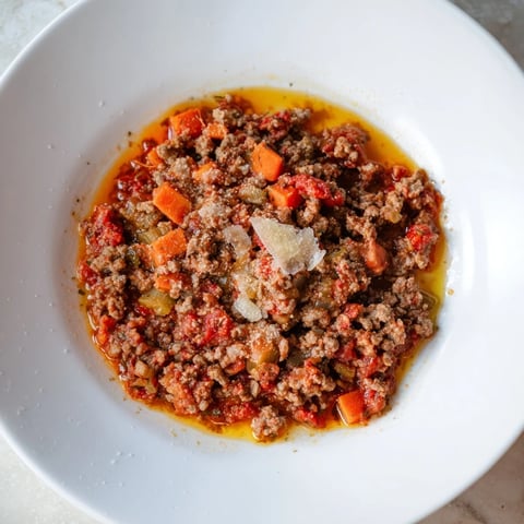 Classic Tuscan Ragu simmering slowly, a hearty meat sauce ready for pasta and cheese.