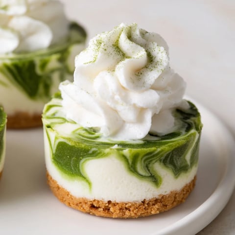 Matcha Swirl Snowdrift Cheesecake Cups: Close-up showing creamy, layered textures, a beautiful no-bake dessert.