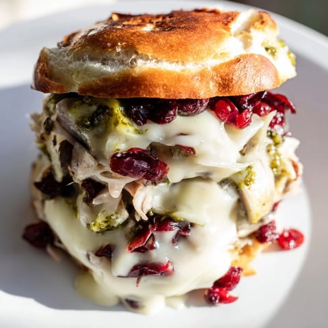 Golden, melty Pesto Cranberry Turkey Grilled Cheese, oozing with cheese and ready to eat.