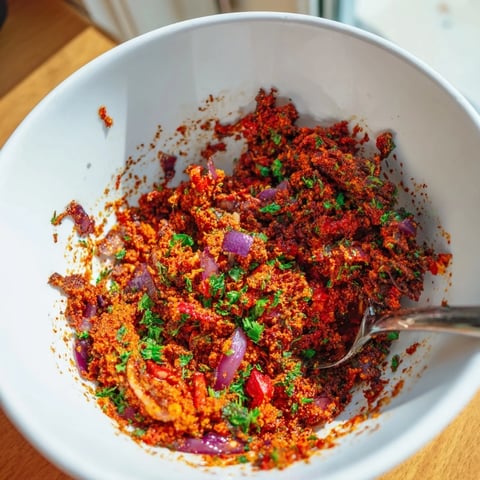 Vibrant red Volcanic Lava Spicy Dip with a swirl of cool yogurt, ready to serve with dippers.