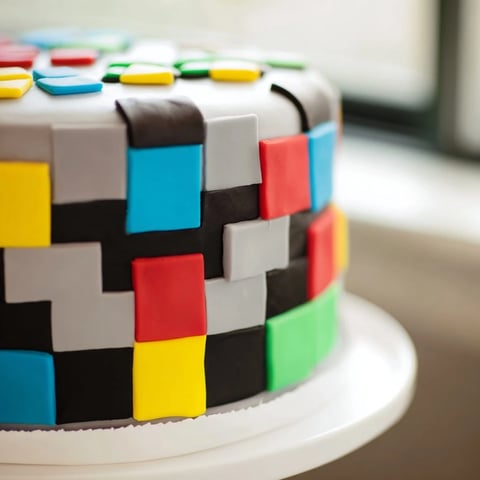 A colorful Pixel Video Game Controller Cake, displaying vibrant fondant details, perfect for a gamer's birthday.