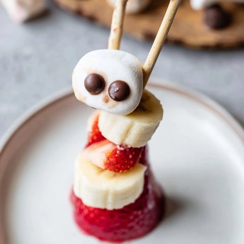 Festive strawberry banana Santa sticks: vibrant red berries and banana slices assembled for snacking.