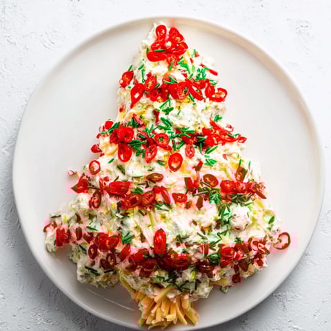 Chili Pepper Christmas Tree Dip, a vibrantly decorated appetizer, arranged with colorful peppers.
