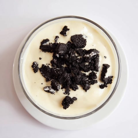 A layered Vanilla Pudding with crushed Oreos showcases creamy texture and chocolatey crunch for dessert.
