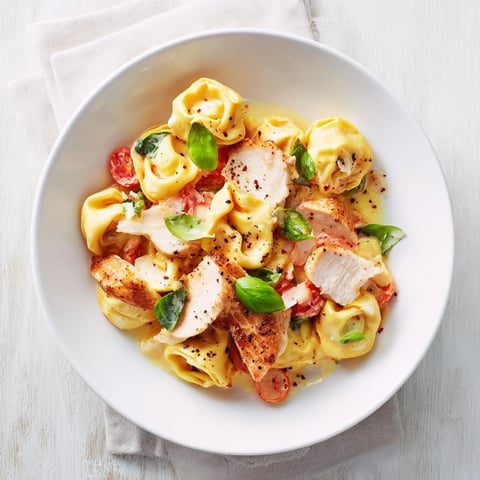 Creamy Marry Me Chicken Tortellini with sliced chicken; imagine the rich, cheesy sauce coating pasta.