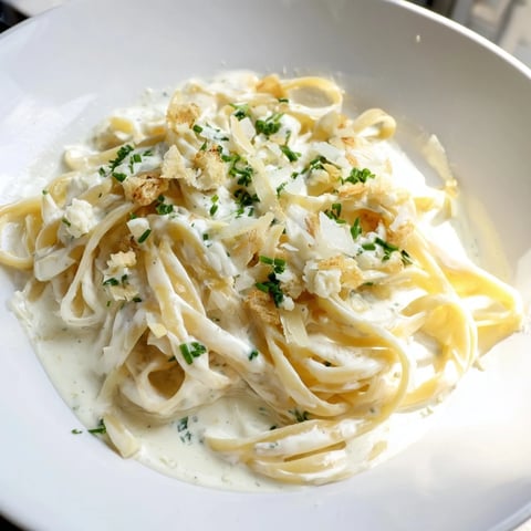 Creamy lemon-garlic Greek yogurt pasta, swirled with parmesan and fresh parsley, ready to enjoy.
