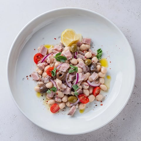 Creamy Dense Chickpea and Tuna Salad with red onion and parsley, a satisfying dish, ready to eat.