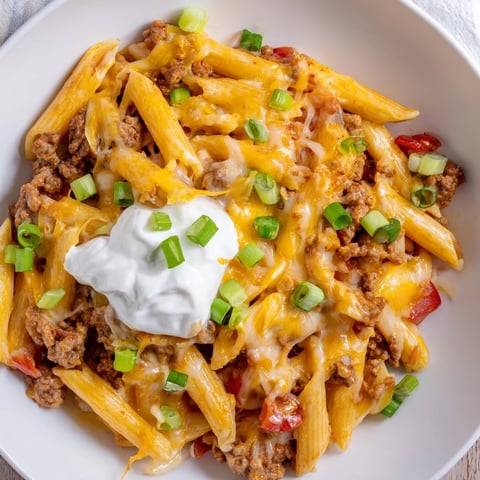 One-Pot Taco Pasta, a bubbling skillet filled with ground beef and melted cheese, ready to serve.