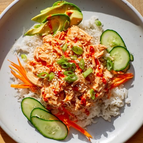 Savory Spicy Canned Salmon Rice Bowl with vibrant colors and drizzled sriracha sauce.
