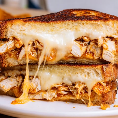 Golden-brown Chili Crisp Honey Chicken Grilled Cheese oozes melted cheese and spicy chicken filling.