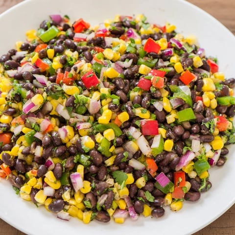 Vibrant Cowboy Caviar Salad boasts colorful peppers, corn, and black beans, perfect for a flavorful side.